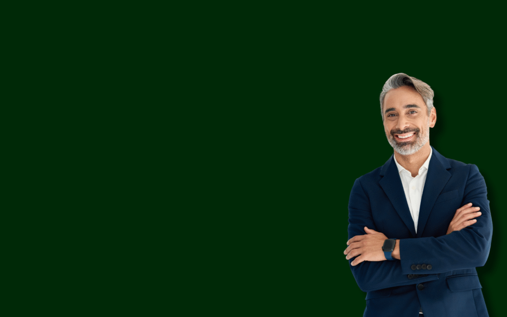 A confident man in a blue suit with arms crossed stands against a green background. He represents a guide for personal injury claims in Alberta, offering expert advice and support for those seeking compensation.